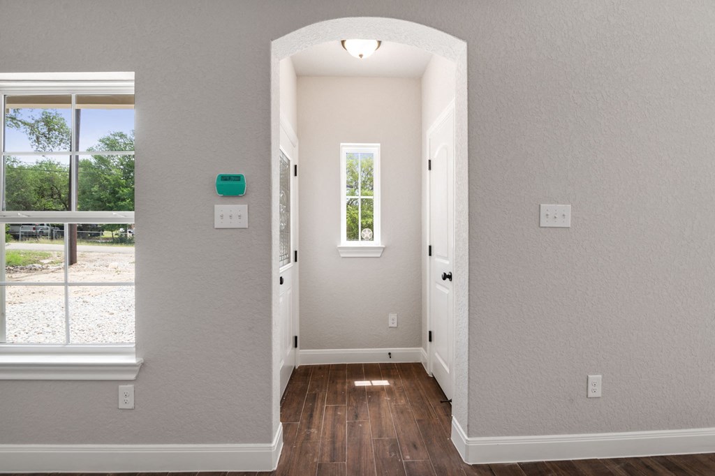 the entryway of a house with a window and a door