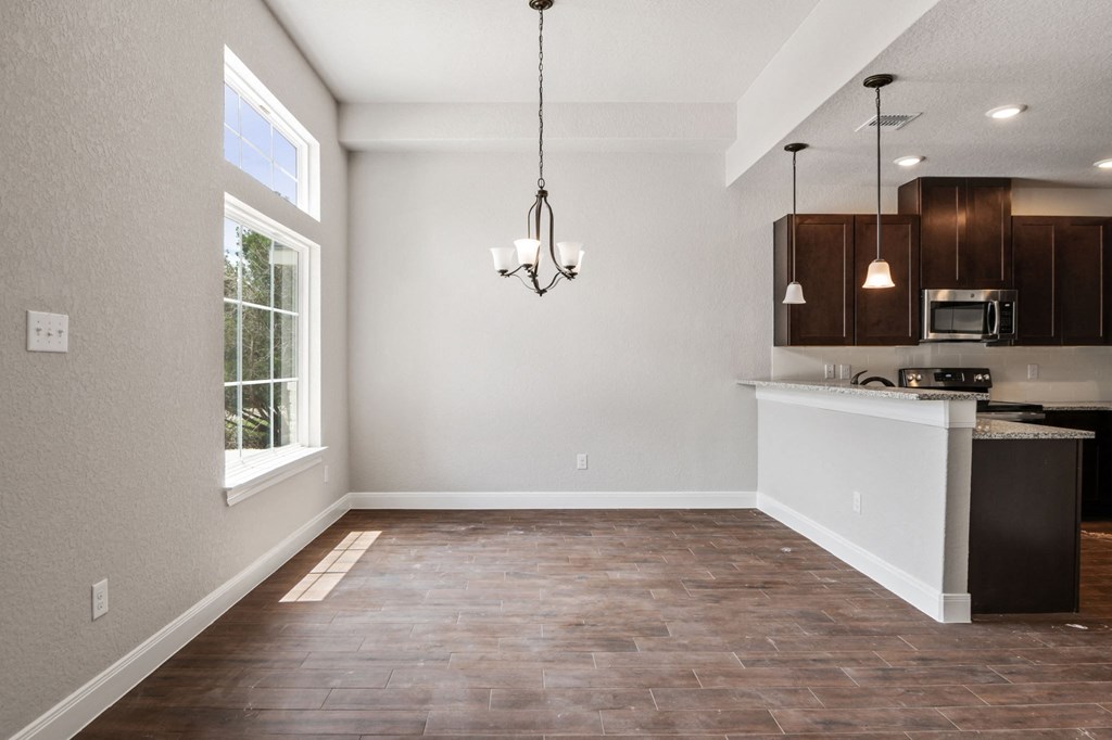 an empty kitchen and living room with a window