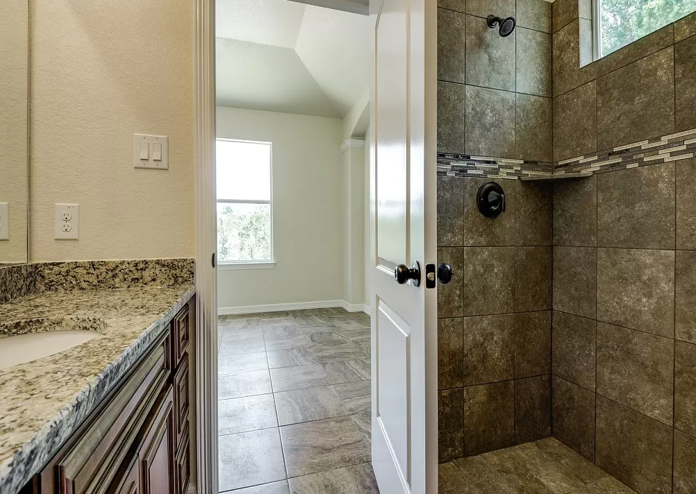 a bathroom with a shower and a sink