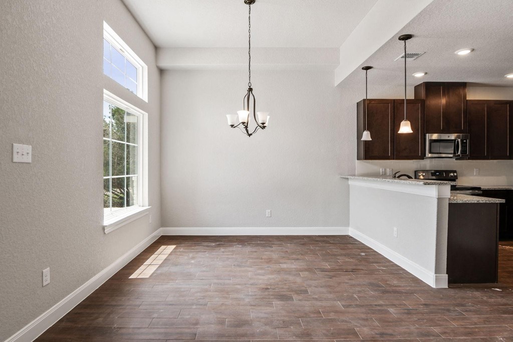 an empty kitchen and living room with a window