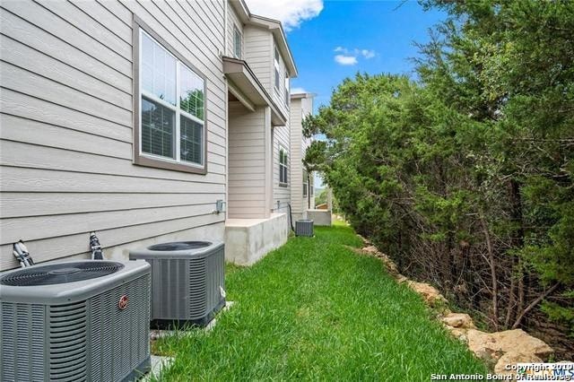 a house with two air conditioning units in the yard