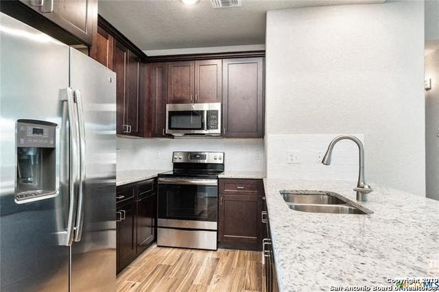 a kitchen with stainless steel appliances and a marble counter top