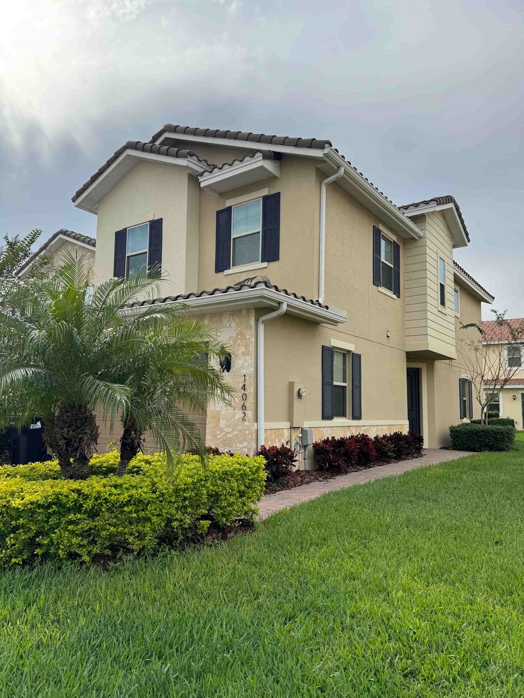 a house with a palm tree in front of it