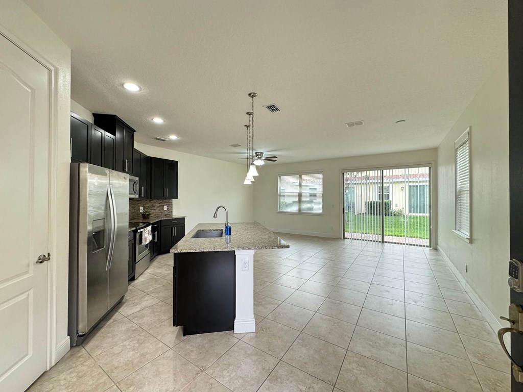 a kitchen with stainless steel appliances and a marble counter top