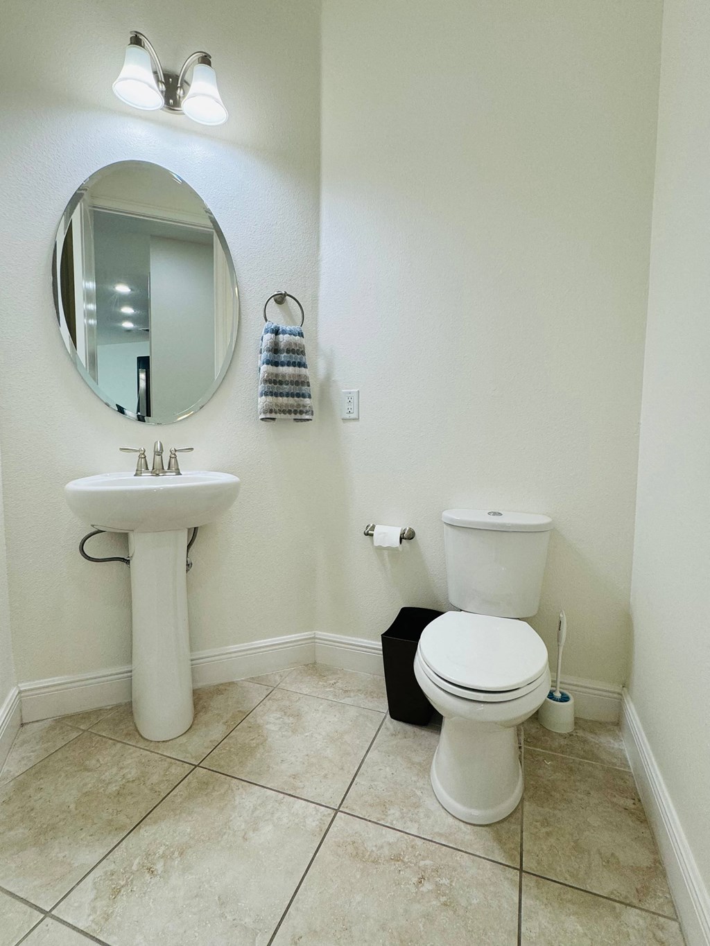 a bathroom with a toilet and a sink and a mirror
