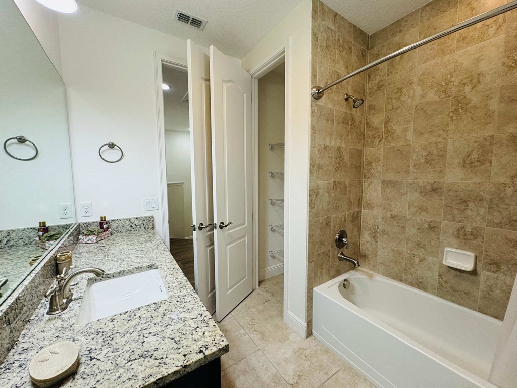 a bathroom with a sink and a tub and a shower