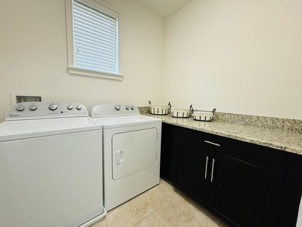 the washer and dryer in the laundry room of a home