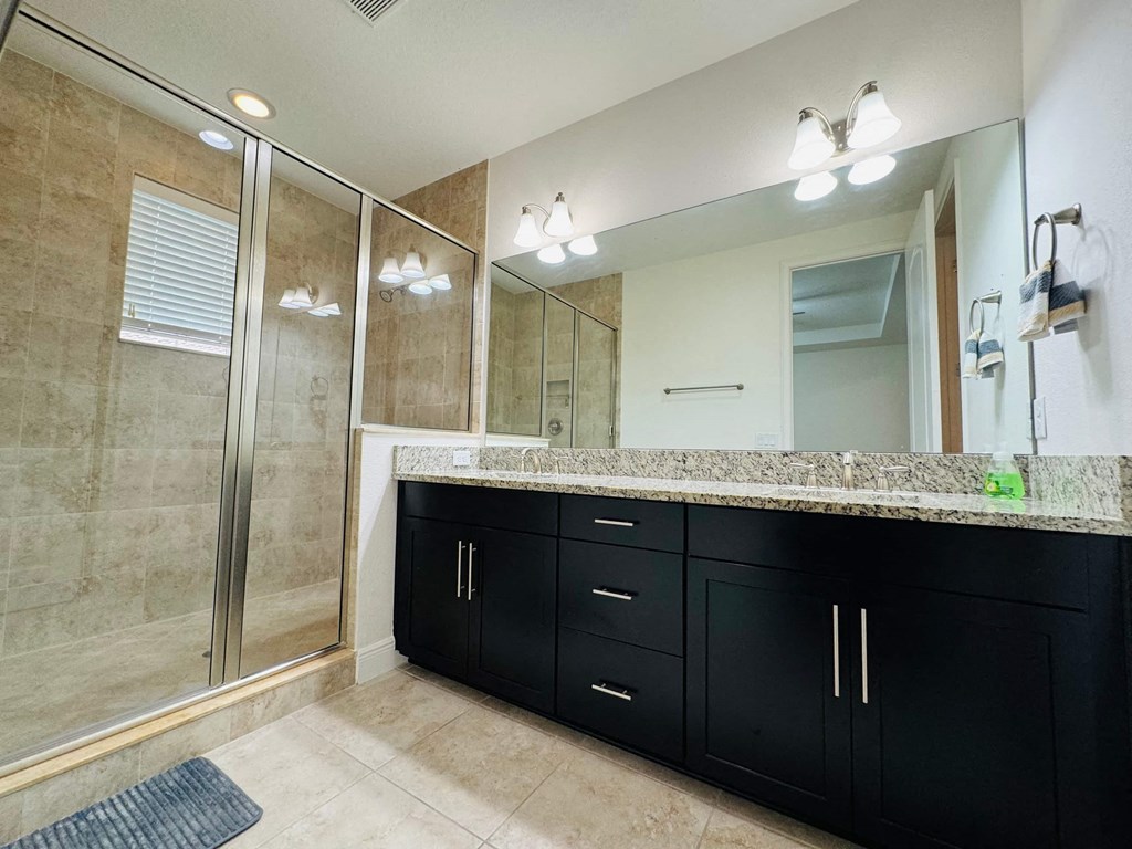 a bathroom with a large mirror and a shower