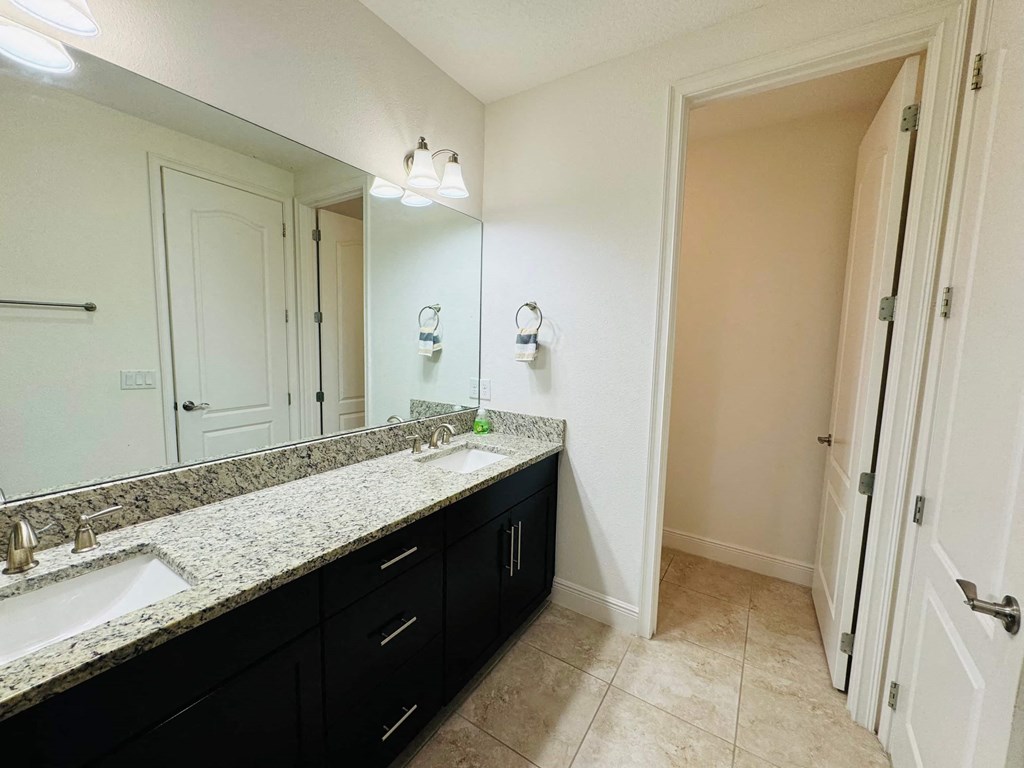 a bathroom with two sinks and a large mirror
