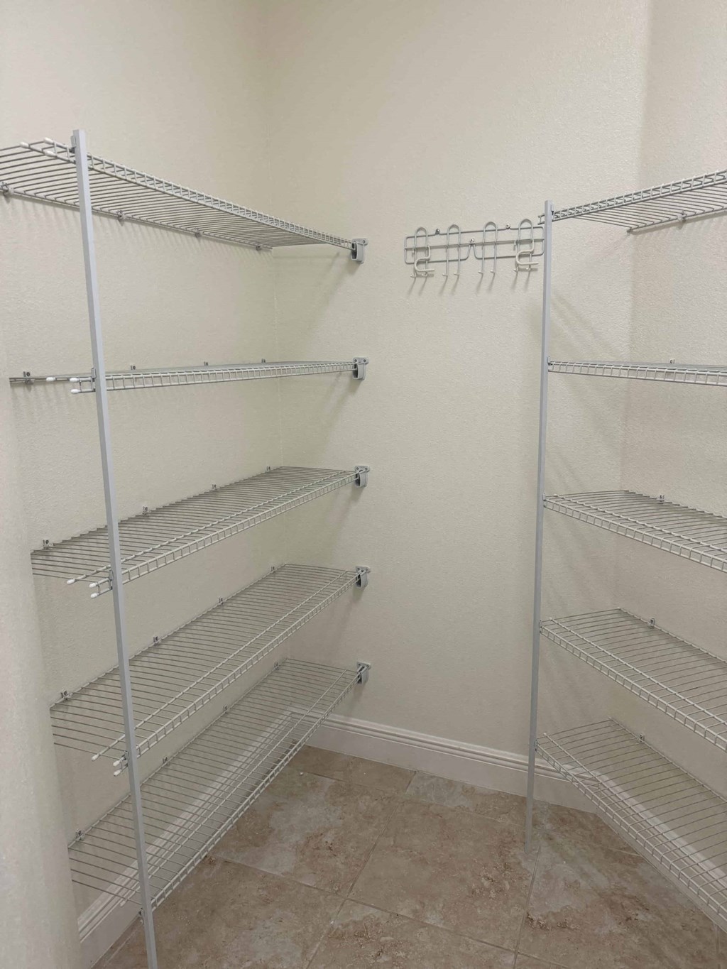 a walk in closet with empty shelves