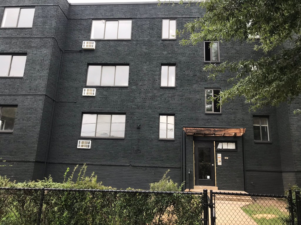 the exterior of a black brick building