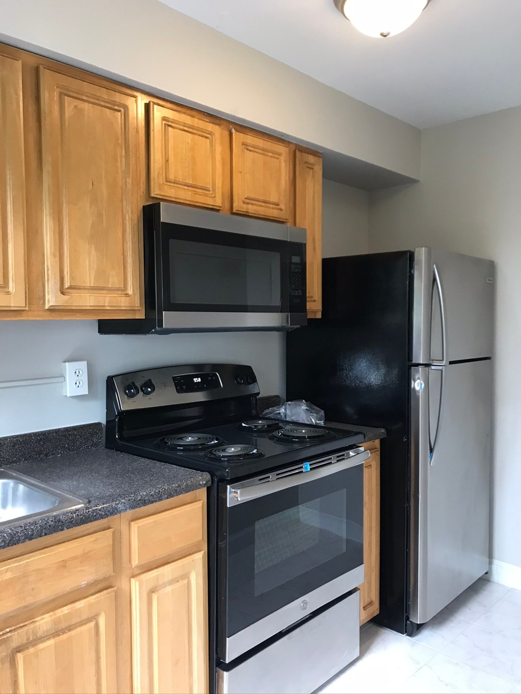 a kitchen with stainless steel appliances and wooden cabinets