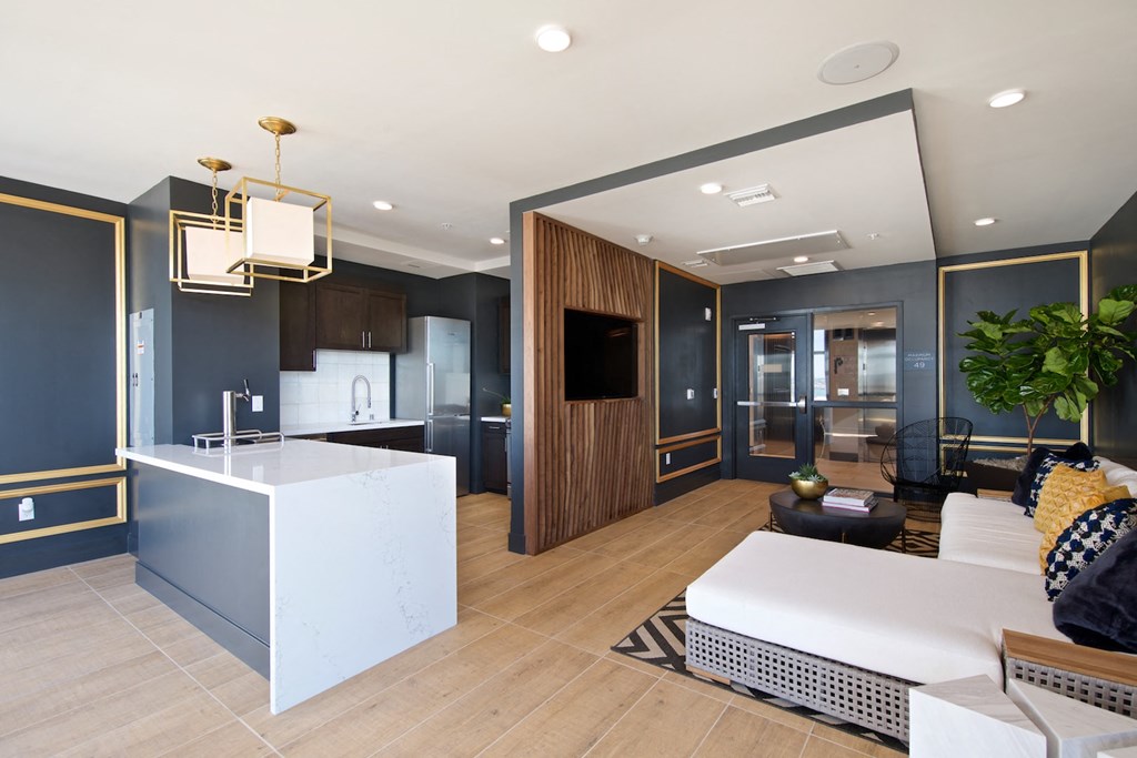 a kitchen and living room with a white couch and a table