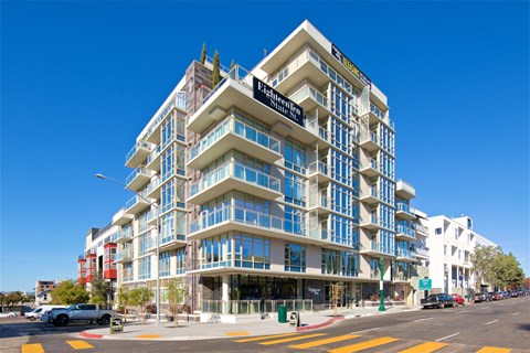 a large apartment building on the corner of a city street