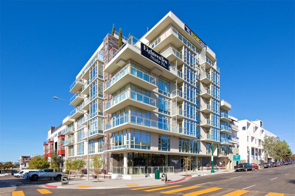 a large apartment building on the corner of a city street