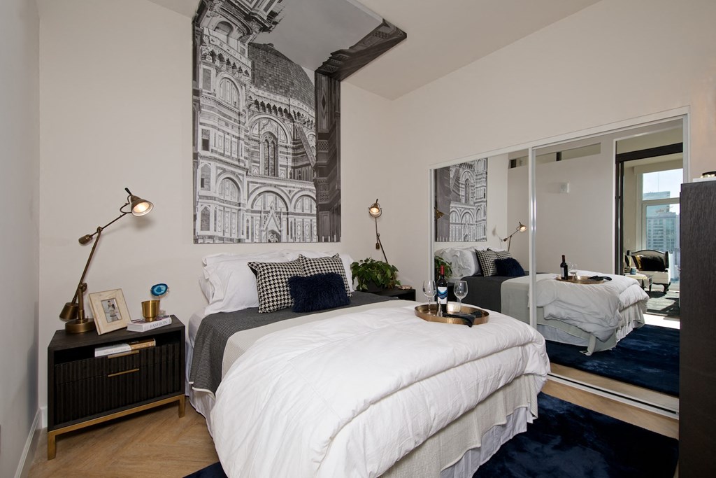 a bedroom with a bed and a large window