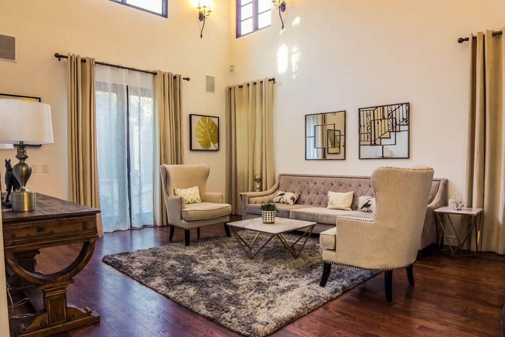 a living room with a couch and chairs