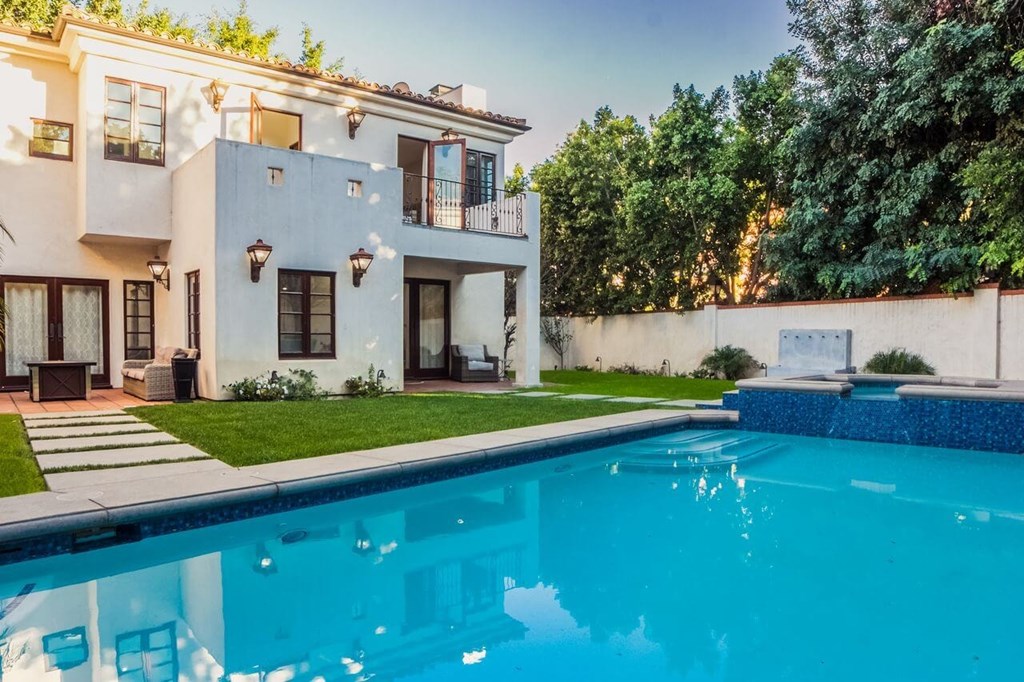 a house with a swimming pool in front of it