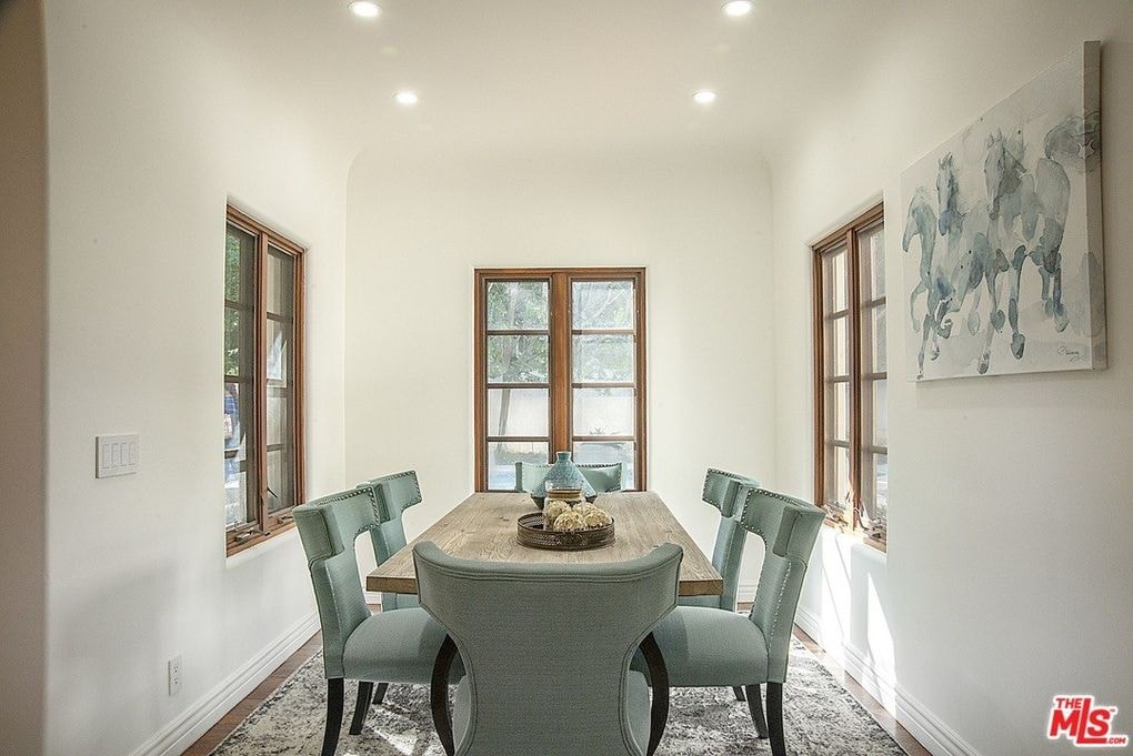 a dining room with a table and chairs