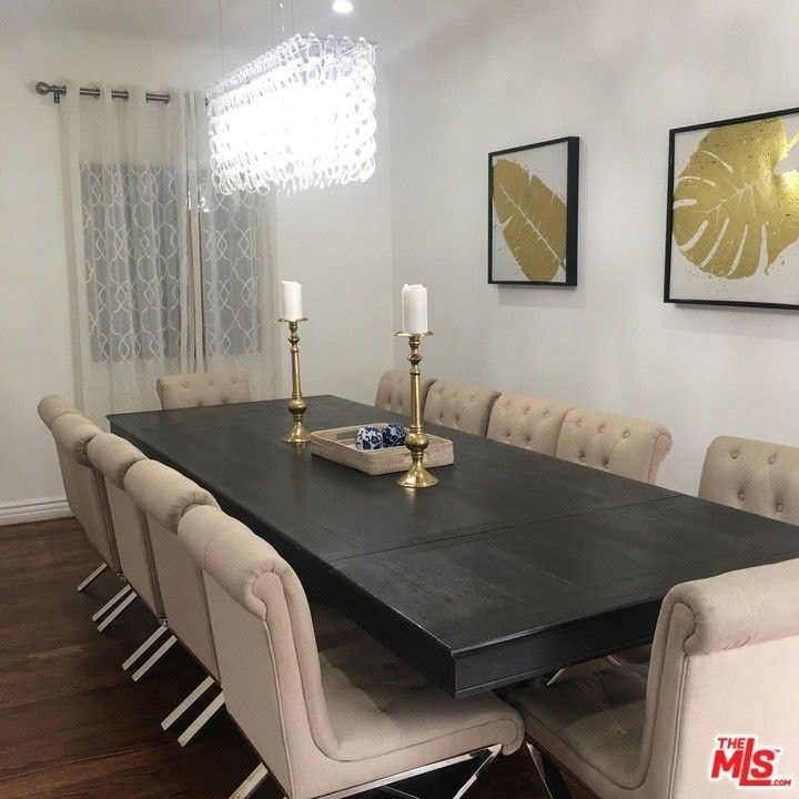a dining room table with chairs and a chandelier