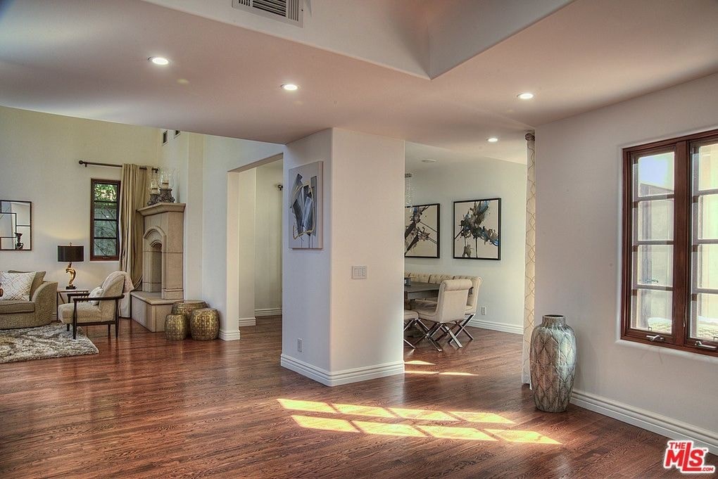 the living room has a fireplace and a large window