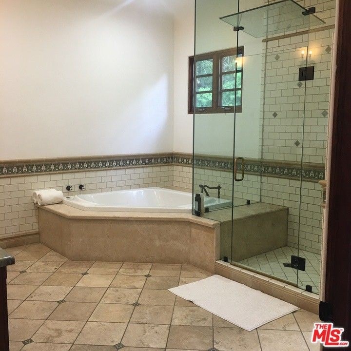 a large bathroom with a large tub and a shower
