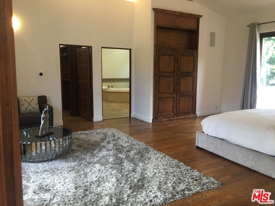 a bedroom with a bed and a door to a bathroom