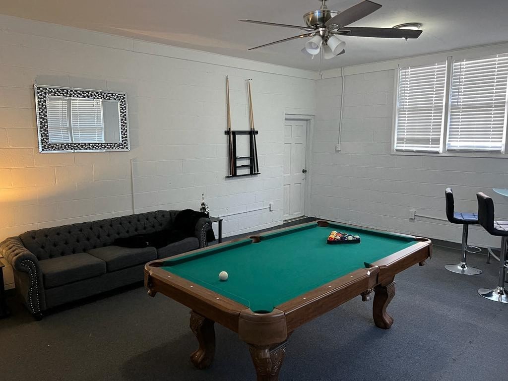 a room with a pool table and a couch