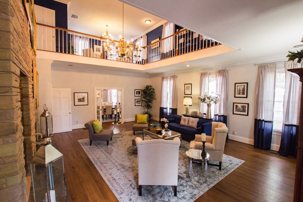 a living room with couches and chairs and a chandelier