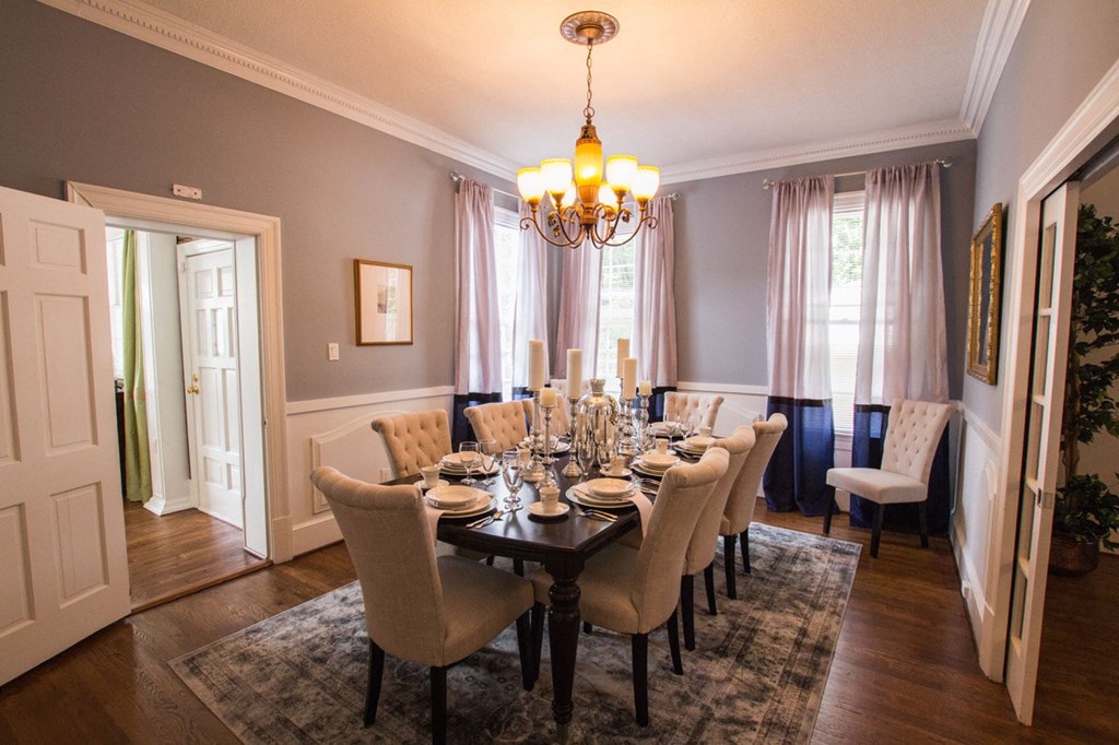 a dining room with a table and chairs and a chandelier