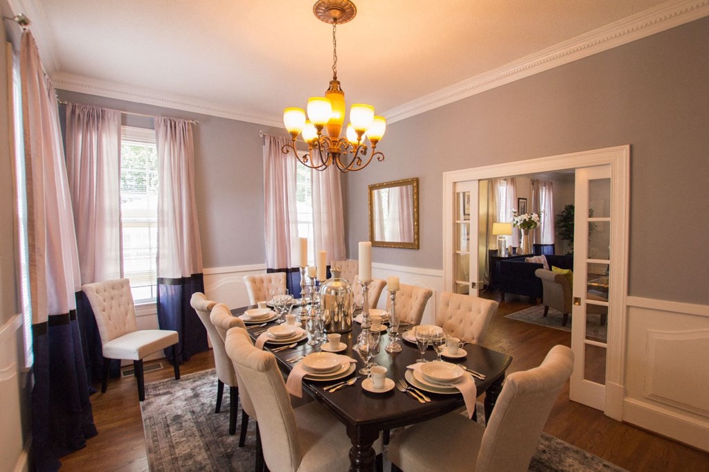 a dining room with a table and chairs and a chandelier
