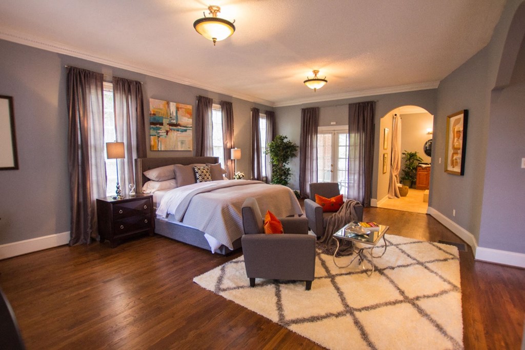 a bedroom with a bed and a couch and a table