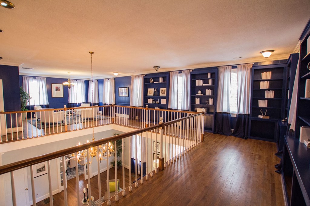 the living room and dining room of a house with blue walls