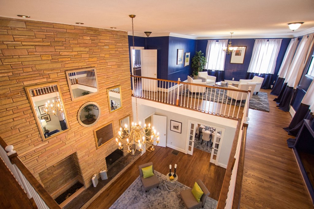 an aerial view of a living room and dining room with a fireplace