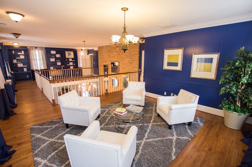 a living room with blue walls and white furniture