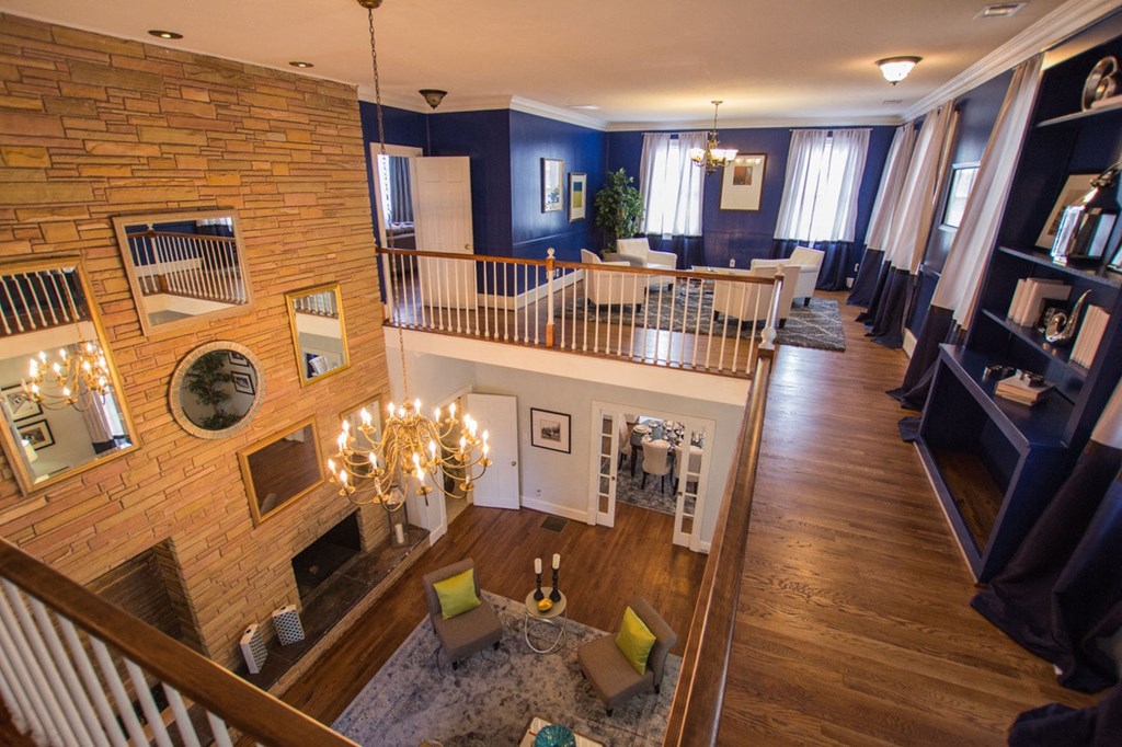 the living room and dining room of a house with a staircase