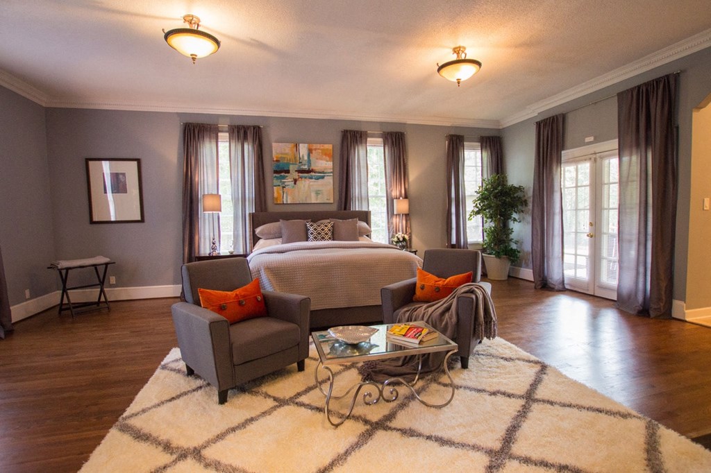 a living room with a bed and a couch and a table