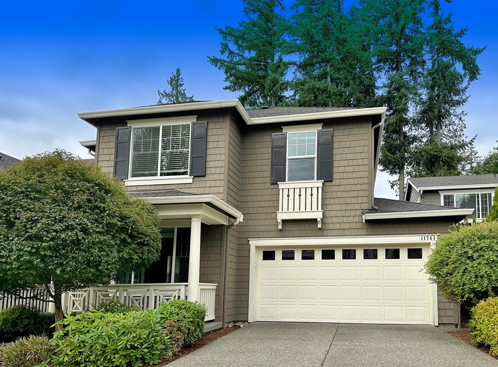 a tan house with a white garage door
