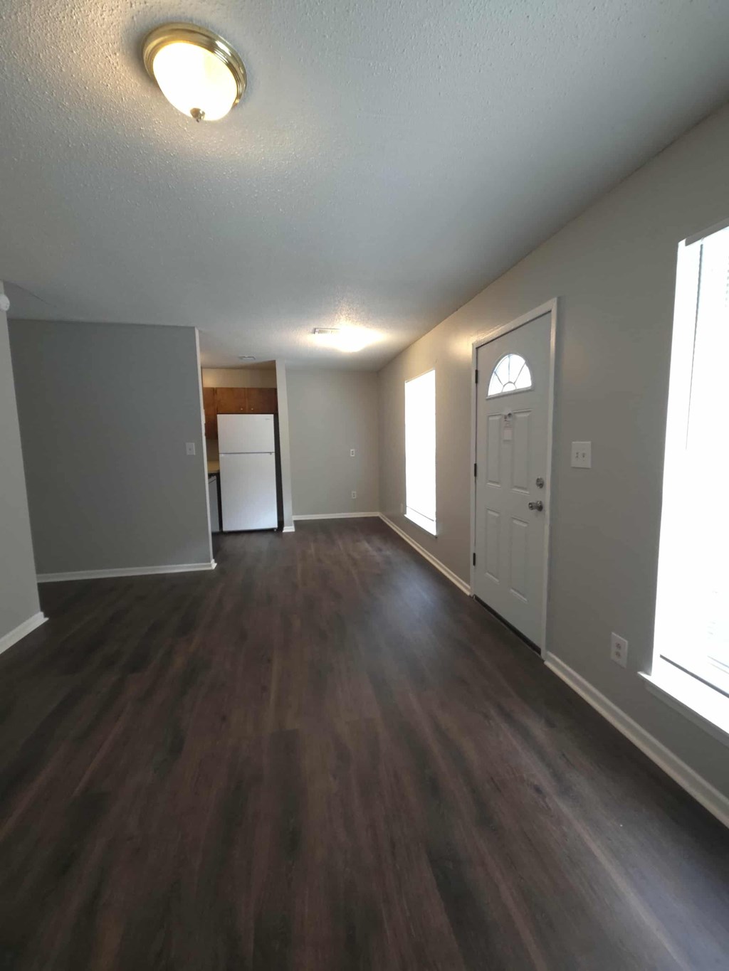 A room with a white door and a window.