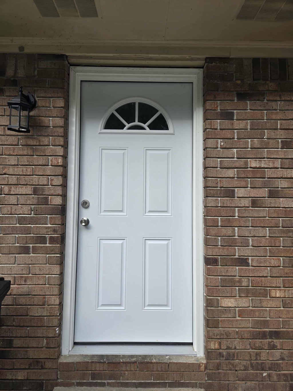 A white door with a glass window above the door.