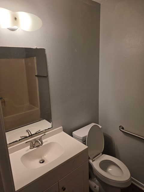 A white sink and toilet in a bathroom.