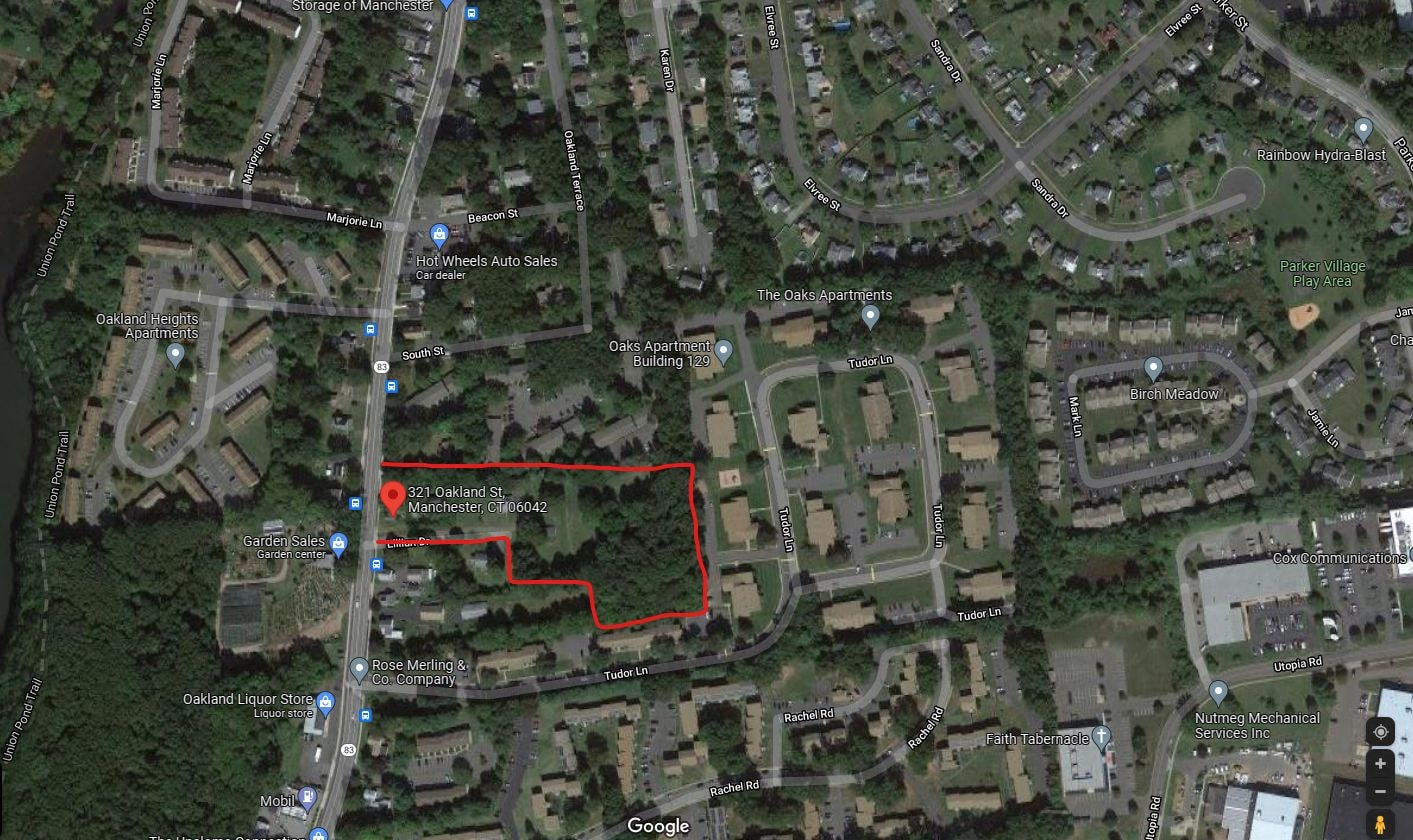 A satellite image of a residential area with a red outline indicating a specific area of interest.