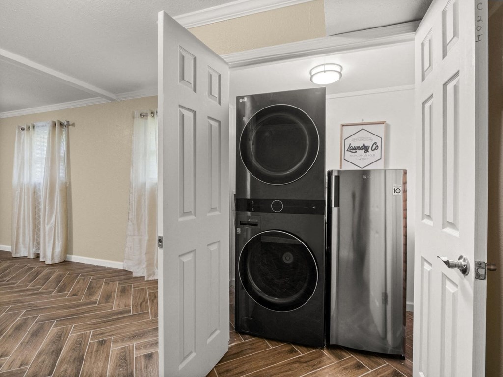 a laundry room with a washing machine and a refrigerator