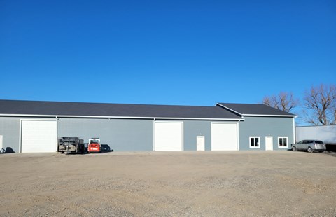 a large garage with a truck parked in front of it