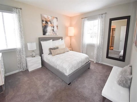 a bedroom with a bed and pillows and a window at Tucker Square, Stone Mountain, 30083