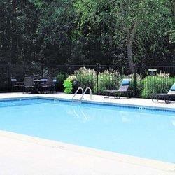 a swimming pool with chairs in front of it at Hidden Creek, Georgia