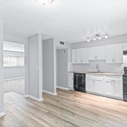 a renovated kitchen with white cabinets and black appliances at Uphill Flats, Decatur, Georgia