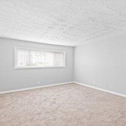an empty room with carpet and a window at Uphill Flats, Decatur