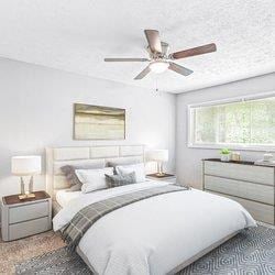 a bedroom with a bed and a ceiling fan at Uphill Flats, Georgia