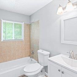 a bathroom with a bath tub and a green rug at Uphill Flats, Decatur, GA